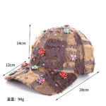 Blue-patchwork-denim-baseball-cap-featuring-distressed-frayed-edges-and-colorful-pearl-jewel-rhinestones-flower-cluster-embellishments-on-a-wooden-background-1