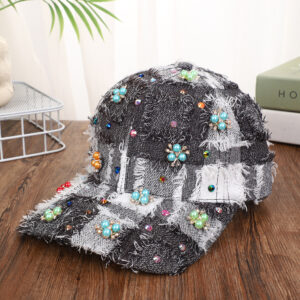 Blue-patchwork-denim-baseball-cap-featuring-distressed-frayed-edges-and-colorful-pearl-jewel-rhinestones-flower-cluster-embellishments-on-a-wooden-background-9