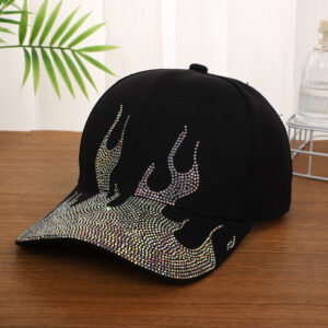 White-baseball-cap-featuring-a-shiny-crystal-rhinestone-flame-pattern-on-the-front-and-brim-placed-on-a-wooden-table-3