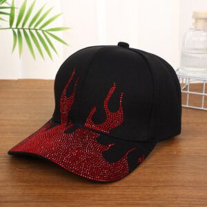 White-baseball-cap-featuring-a-shiny-crystal-rhinestone-flame-pattern-on-the-front-and-brim-placed-on-a-wooden-table-4