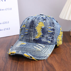 Wholesale-washed-black-denim-baseball-cap-with-custom-distressed-ripped-holes-revealing-a-bright-blue-underlayer-displayed-for-bulk-clothing-supplier-1