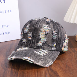 Wholesale-washed-black-denim-baseball-cap-with-custom-distressed-ripped-holes-revealing-a-bright-blue-underlayer-displayed-for-bulk-clothing-supplier-11