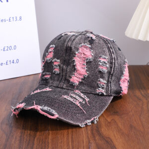 Wholesale-washed-black-denim-baseball-cap-with-custom-distressed-ripped-holes-revealing-a-bright-blue-underlayer-displayed-for-bulk-clothing-supplier-2