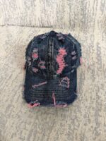 Wholesale-washed-black-denim-baseball-cap-with-custom-distressed-ripped-holes-revealing-a-bright-blue-underlayer-displayed-for-bulk-clothing-supplier-3
