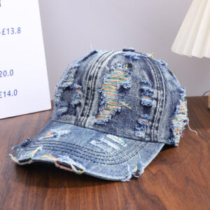 Wholesale-washed-black-denim-baseball-cap-with-custom-distressed-ripped-holes-revealing-a-bright-blue-underlayer-displayed-for-bulk-clothing-supplier-9