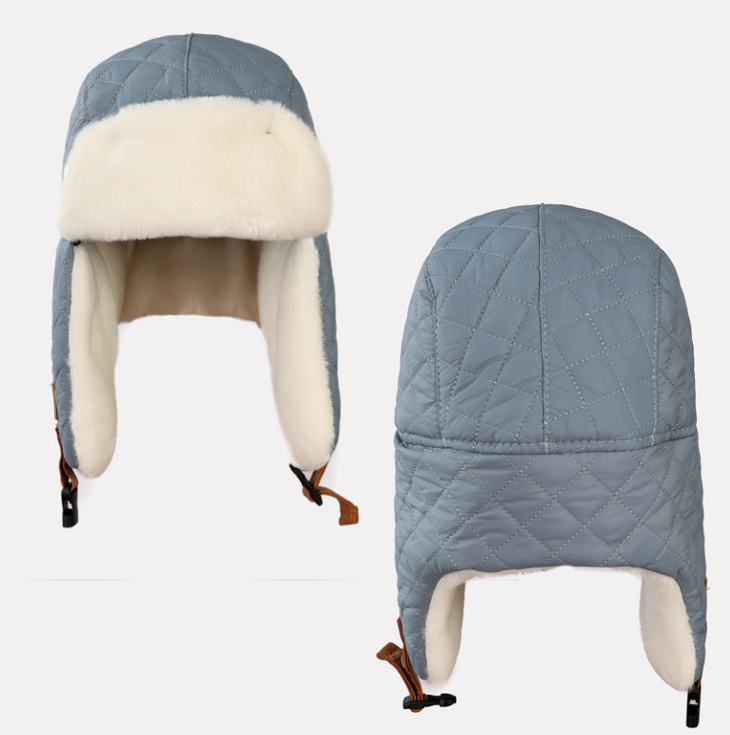 Three-kids-quilted-winter-trapper-hats-in-off-white-coral-pink-and-grey-blue-featuring-plush-white-faux-fur-lining-and-adjustable-chin-straps-2