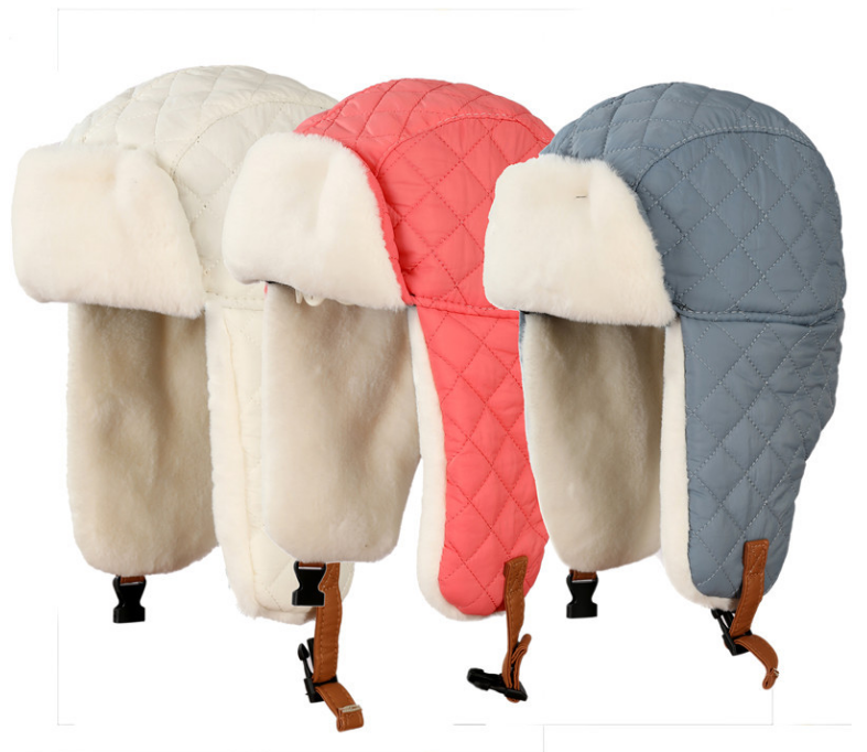 Three-kids-quilted-winter-trapper-hats-in-off-white-coral-pink-and-grey-blue-featuring-plush-white-faux-fur-lining-and-adjustable-chin-straps-3